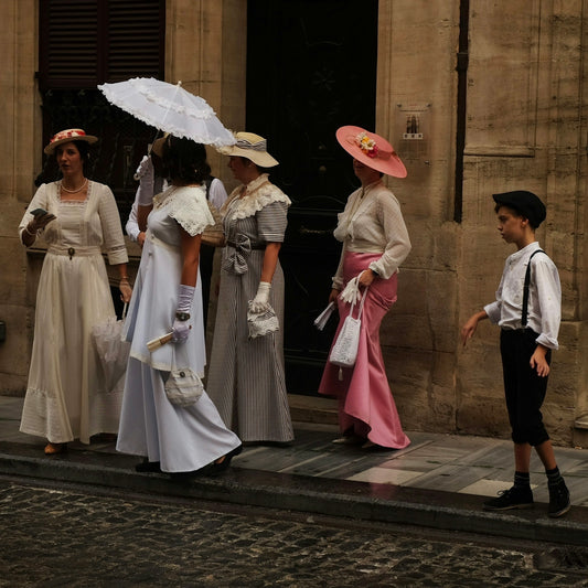 People in vintage clothes pose in the street